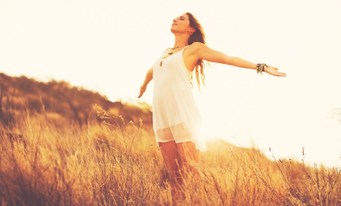 woman-arms-outstretched-sun-behind-her-face-to-sky-feeling-of-self-worth-know-your-story-blog