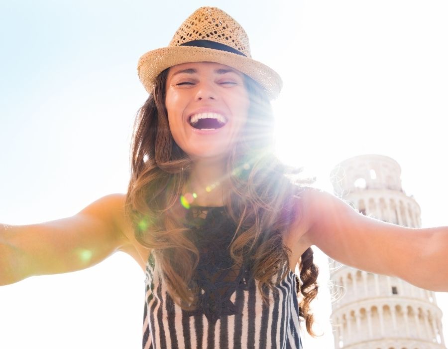 woman-smiling-into-camera-selfie-sun-behind-positive-thinking-blog-post