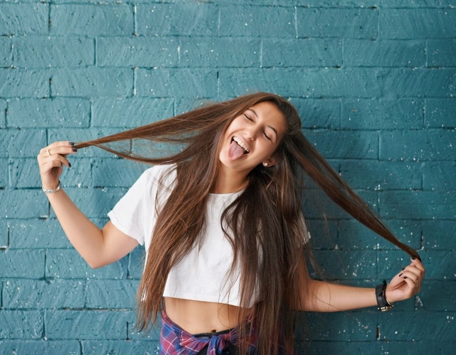 woman-long-brown-hair-sticking-tongue-out-holding-hair-out-on-both-sides-be-authentic-blog-post