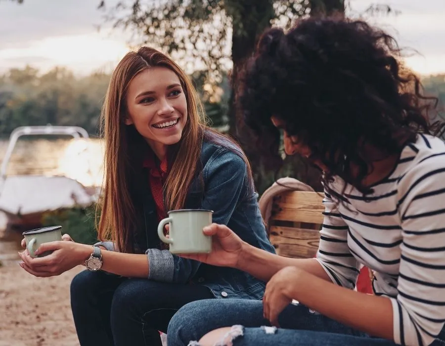 two-women-friends-sitting-around-campfire-talking-learn-to-listen-blog-post