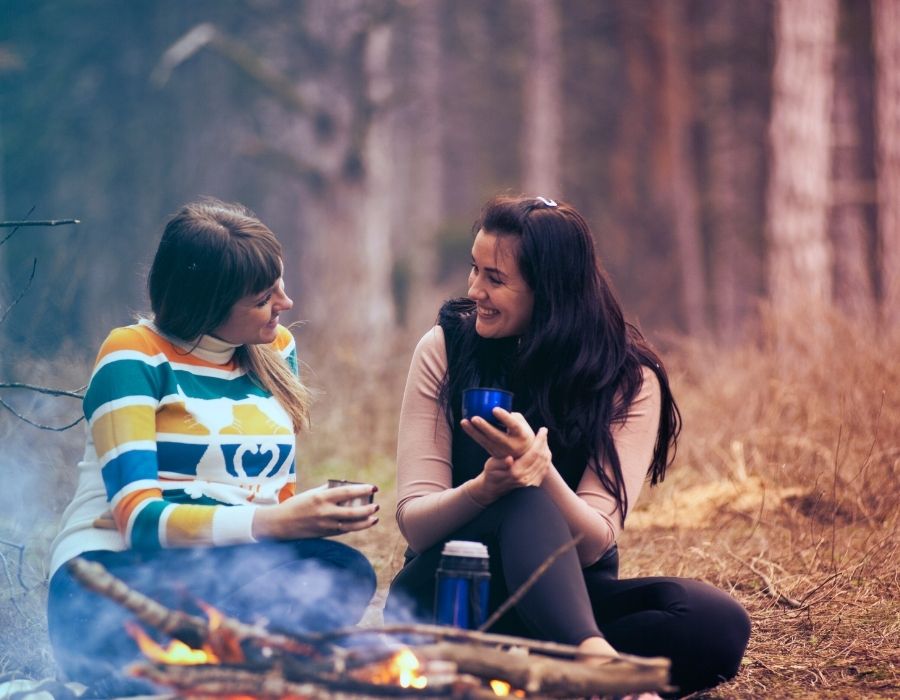 friends-sitting-at-camp-fire-talking-the-importance-of-listening-blog-post